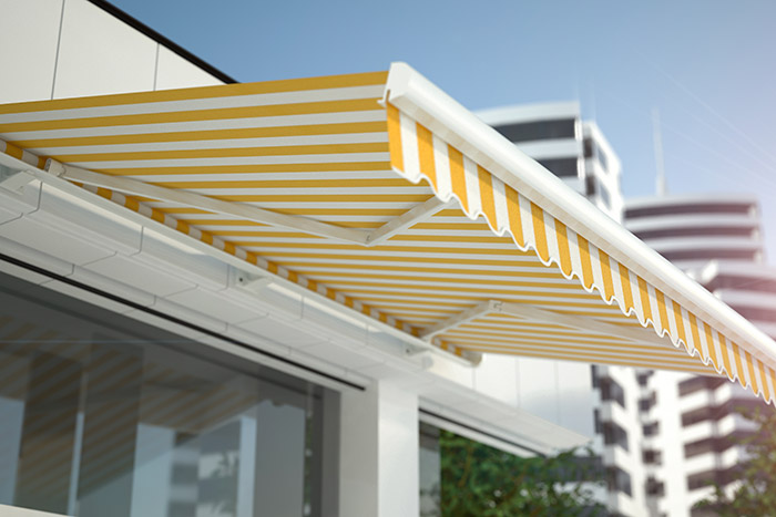 white and yellow striped retractable awning